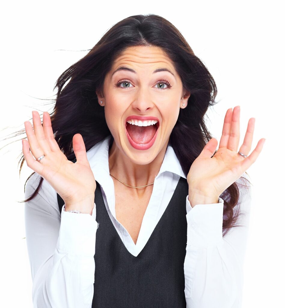 A woman displays a surprised expression, her eyes wide and mouth slightly open, conveying astonishment or disbelief.