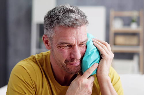 man suffering from severe tooth pain in Midvale